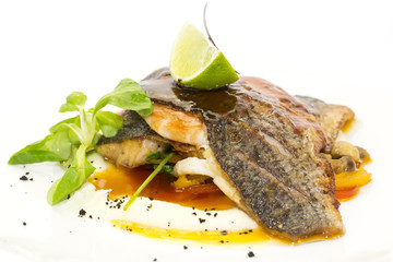 baked fish with vegetables and mushrooms in a restaurant