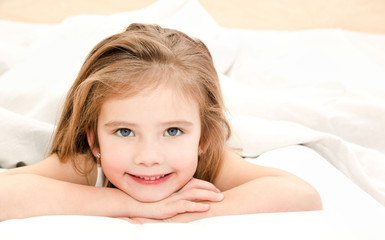 Fototapeta premium Adorable smiling little girl waked up