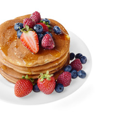 Pancakes with berries and honey over white