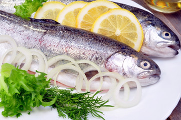 two rainbow trout with lemon and fresh vegetables