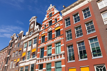 Fototapeta na wymiar Colorful houses facades in sunny day above blue sky. Amsterdam