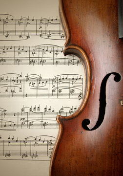 Detail of old scratched violin on music sheet