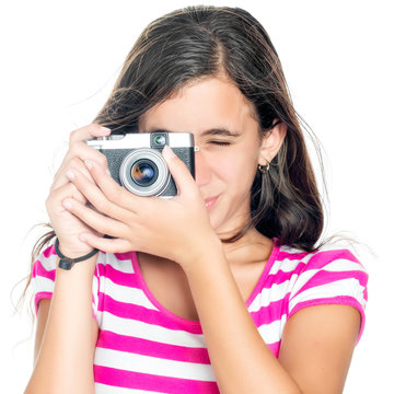 Young girl using a compact camera isolated on white