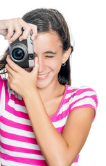 Fun happy young girl taking a photo isolated on white