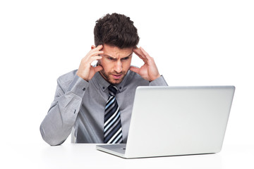 Stressed man looking at laptop