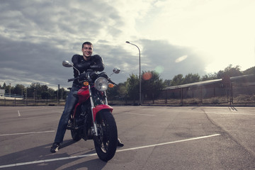 biker posing on motorbike