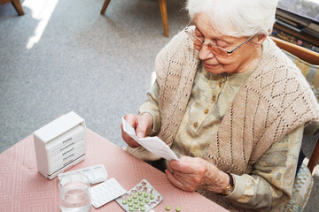 Elderly woman with pills