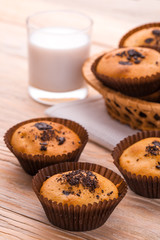 Freshly muffins with milk on the light  table