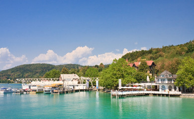Fototapeta premium Pier and a restaurant on the shore of Lake Worth. Carinthia. Res