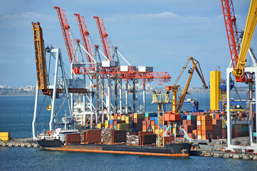 Fototapeta na wymiar Bulk cargo ship under port crane bridge, Odessa, Ukraine