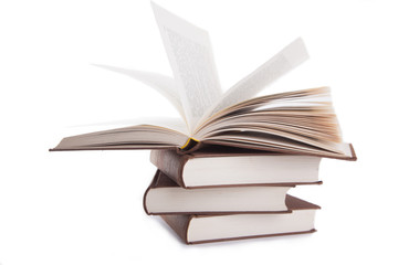 open book on a stack of books isolated