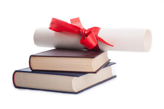 diploma on top of stack of books isolated on white