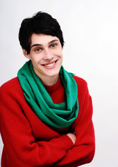 Man dressed in red sweater with scarf for a cold winter smiling.