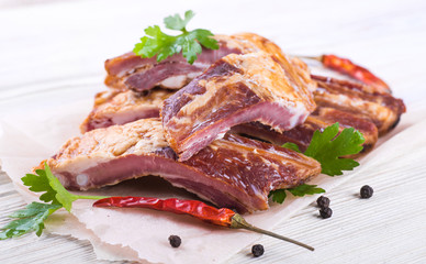 .Smoked lamb ribs on wooden table.