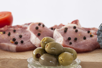 pork chops and olives closeup, isolated