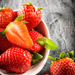 Bowl of succulent ripe red strawberries