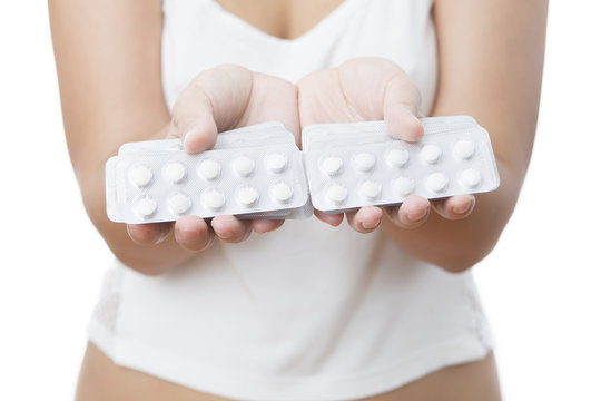 Pills in women hands