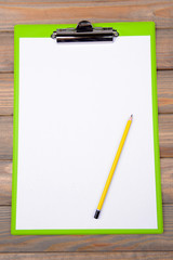Clipboard on wooden background