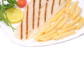 Fried fish fillet with fries and vegetables