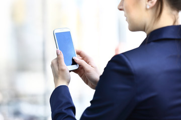 Businesswoman hands holding smartphone