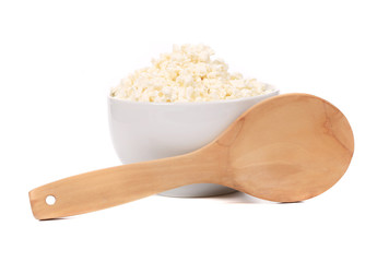 Cottage cheese in bowl with spoon.