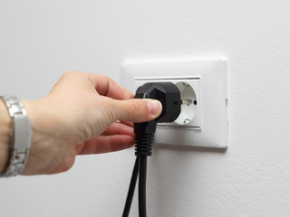 electricity savings concept, woman unplugged plug from the socke