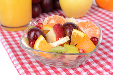 Sweet fresh fruits in bowl on table close-up