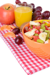Sweet fresh fruits in bowl on table close-up