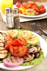 Delicious grilled vegetables on plate on table close-up