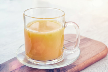 A cup of juice on a wooden board
