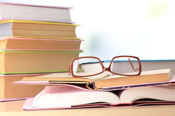 Composition with glasses and books,