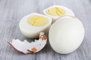 Peeled boiled egg on wooden background