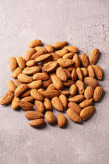 Almonds on color wooden background