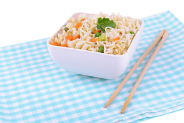 Tasty instant noodles with vegetables in bowl on table close-up