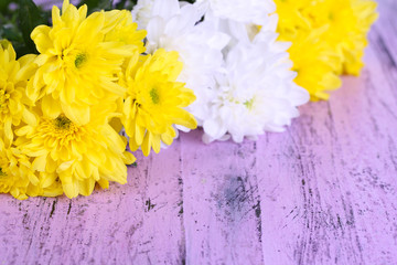 Beautiful chrysanthemum flowers on wooden table close-up