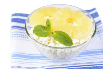 Bowl of tasty cottage cheese with pineapple, close up