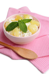 Bowl of tasty cottage cheese with pineapple, close up