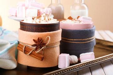 Mug of hot drink decorated in felt on wooden table