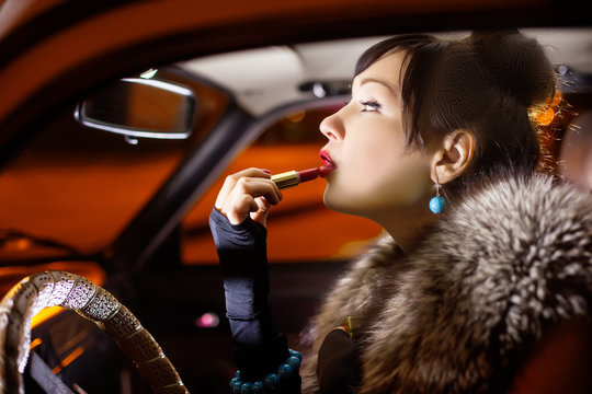 Woman Putting Makeup In Car