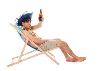 Young man at the beach drinking beer