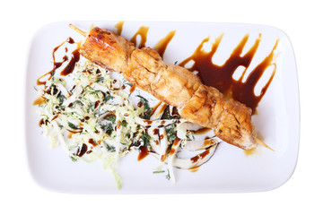 Top view of plate with chicken skewer