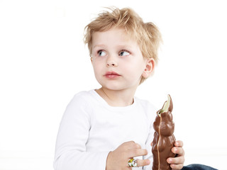 Cute little boy with chocolate bunny