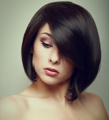 Art portrait of short hair woman looking down. Closeup