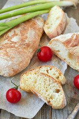 Fresh bread ciabatta and cherry tomatoes.