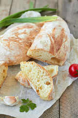Fresh bread ciabatta and cherry tomatoes.