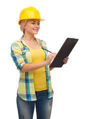 smiling woman in helmet with clipboard