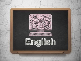 Education concept: Computer Pc and English on chalkboard