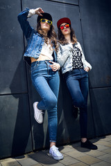 Young  girls with denim suit in a urban background