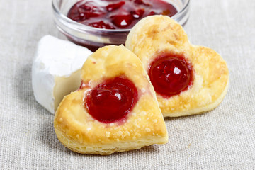 Puff pastry cookies in heart shape filled with cherries
