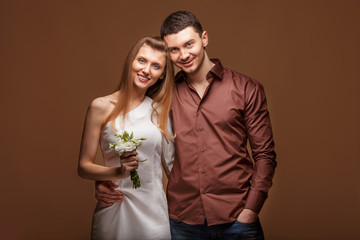 Beautiful couple in love with bouquet flowers. Valentine Day